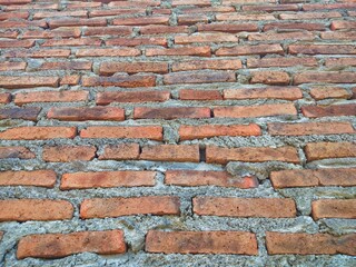 Red brick wall that has been plastered and smoothed with cement