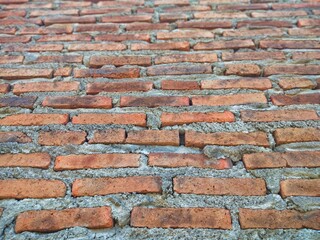 Red brick wall that has been plastered and smoothed with cement