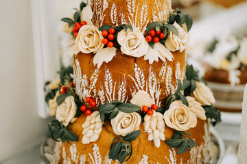 Beautifully decorated three-tier cake with flowers and foliage for a special occasion