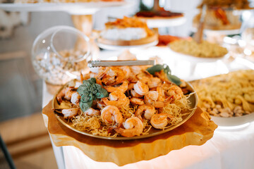 Shrimp dish served on platter at upscale dining event in bright setting