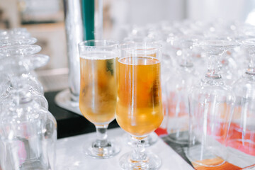 Delicious craft beers served in elegant glasses at a bustling bar during an evening event