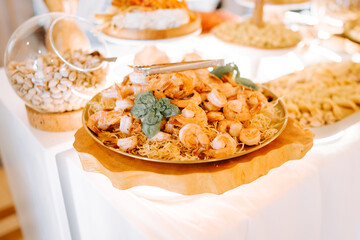 Delicious seafood dish featuring shrimp and noodles served at a festive culinary gathering