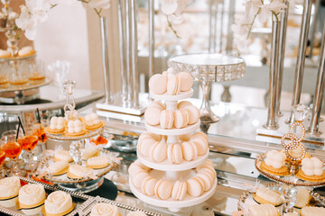Elegant dessert display featuring macarons and cakes at a celebration venue