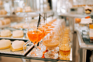 Colorful cocktails and desserts displayed elegantly at a modern event setting