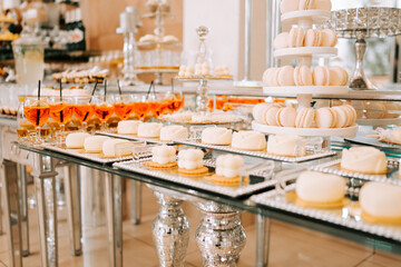 Elegant dessert display at a luxurious event showcasing various pastries and drinks