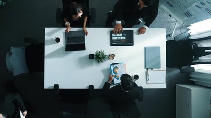 Top view of smart diverse team walk at meeting table and start to discuss about financial statistic. Group of business people prepare for meeting while looking at stock market document. Directorate. - Powered by Adobe