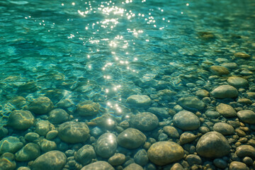 Sparkling turquoise river water, sunlight reflecting on surface, smooth stones underwater, summer nature background, tranquility and purity concept