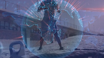 Animation of spinning globe against african american fit man working out with medicine ball at beach