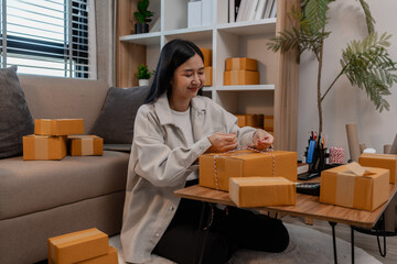 she is packing parcel to send to all customers, this entrepreneur own a small business, sme,...
