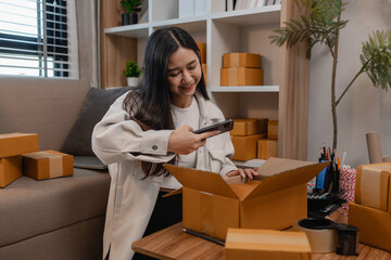 she is packing parcel to send to all customers, this entrepreneur own a small business, sme,...