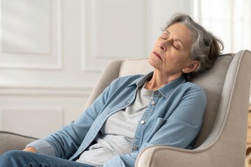 x-default Senior woman relaxing in a comfortable armchair