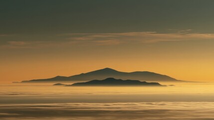 Fototapeta premium Expansive landscape view during sunrise or sunset with sea fog covering a large body of water,