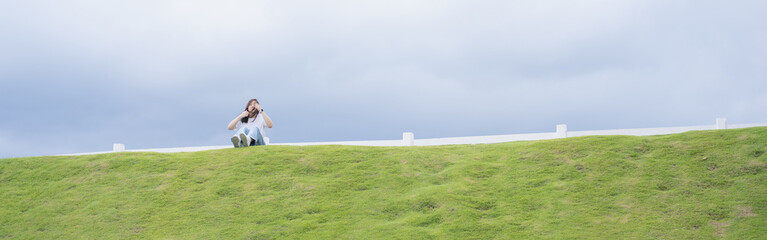 Relax and wellness concept with woman sit on road in garden and mountain background at chiangmai thailand in raining season