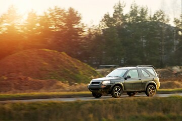 Family car driving in rural setting