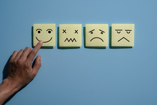 Happy smile face for medical care concept,Mind, Mental Health Concept. Varieties of Mood and Emotion Inside Out. many Sticky Notes on Board with Handwriting Cartoon Emoticon Face