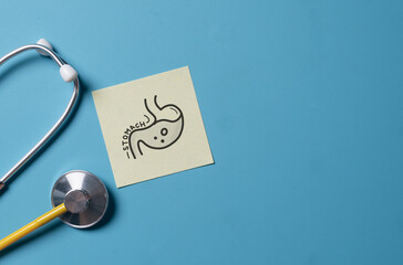 Doctor's Stethoscope Checking with Stomach on blue background,Medical Concept,checkup all organs