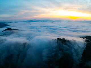 Amazing Sunrise over mountains hills covered with mist, Aerial view landscape drone shot beautiful sky colorful light nature background