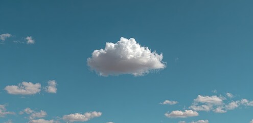 Single fluffy white cumulus cloud against a vibrant teal blue sky