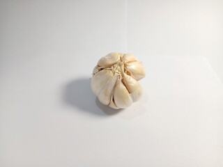 garlic with the shell still on it with a white background