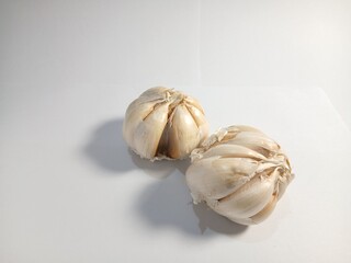 garlic with the shell still on it with a white background