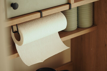 Kitchen shelf displaying paper towels and kitchenware