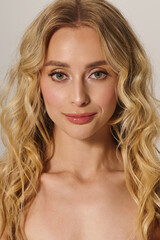 Fashionable young woman with blonde hair captivates with her stylish elegance in a studio setting