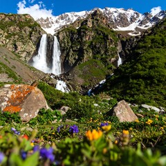 Mountain waterfall scene with wildflowers