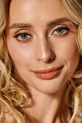 Radiant young woman with blonde curls showcases her natural beauty in a stylish setting