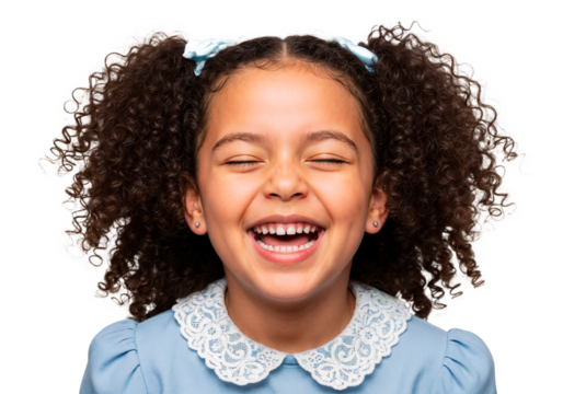 Happy girl with curly hair laughing joyfully in a light blue dress against a white background