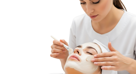 Beautician applying a facial mask to a clients face during a spa treatment