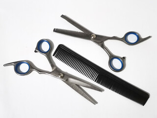 Hairdressing tools isolated on white surface for professional styling and grooming work in salons.
