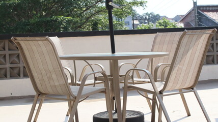 Chairs and tables in a coffee cafe are neatly arranged on the rooftop.