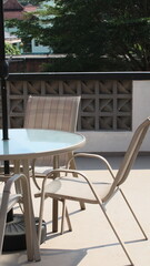 Chairs and tables in a coffee cafe are neatly arranged on the rooftop.
