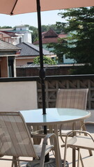 Chairs and tables in a coffee cafe are neatly arranged on the rooftop.