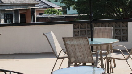 Chairs and tables in a coffee cafe are neatly arranged on the rooftop.