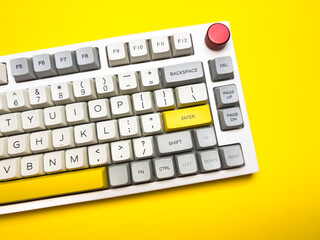 White mechanical keyboard with bright Enter key on bright yellow background, minimalism, keyboard...