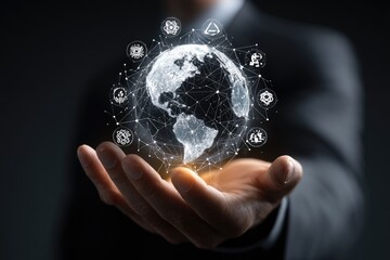 A person's hand holds a 3D holographic globe, connected by a network, with various symbols around it