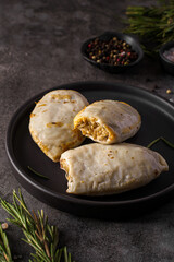 frozen squid stuffed with rice on a dark background