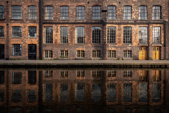Old brick factory building alongside a canal