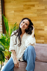 Confident woman taking a break, casual home portrait.
