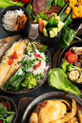 Table scene of various delicious foods. Healthy, family dinner.