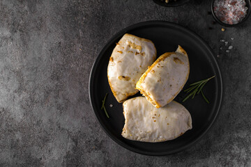 frozen squid stuffed with rice on a dark background