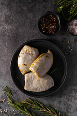 frozen squid stuffed with rice on a dark background