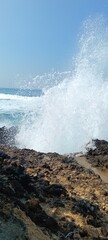 splashing sea waves on large rocks