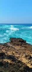 view of the sea waves from the top of the rocks
