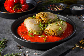 squid stuffed with rice with tomato and pepper sauce