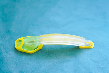I-gel supraglottic airway tube (size 3) placed on a green background, medical device used for...