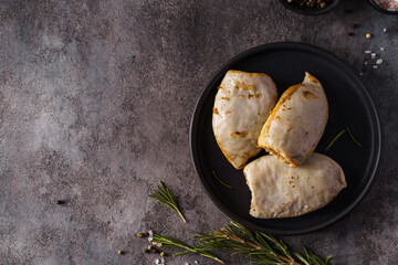frozen squid stuffed with rice on a dark background