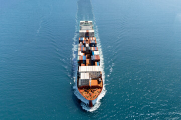 Giant container ship heavy ship goes on water with a lot of cargo in the sea strait when entering...