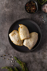 frozen squid stuffed with rice on a dark background
